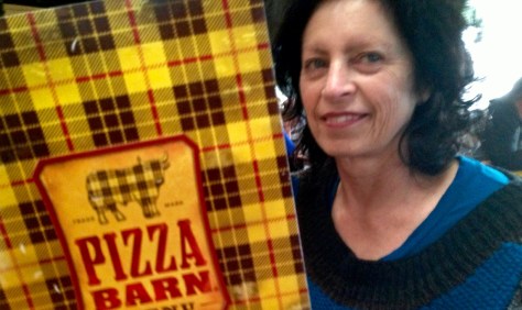 Fiona with the menu in McLeod tartan at the Pizza Barn