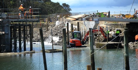A digger in the water preparing the bridge