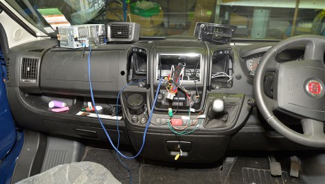 The stereo on the dash with the blue sub wires plugged in