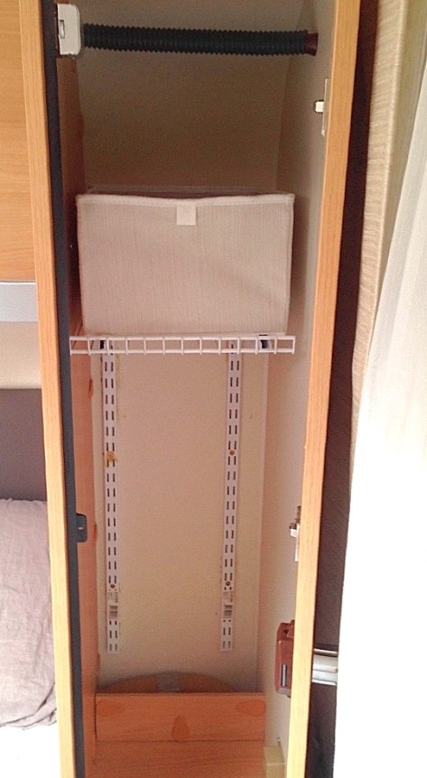 The screwed rails with the first shelf in