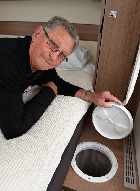 Walter lying across the bed showing the top of the laundry chute.